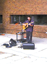 Singer/Songwriter Raymond Gonzalez, performing under shelter of the Science Building
 