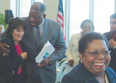 Chancellor Keith Motley embraces Carol Hardy Fanta, director of the Center for Women in Politics and Public Policy, after his convocation speech. Motley´s mother is pictured in the foreground.
 