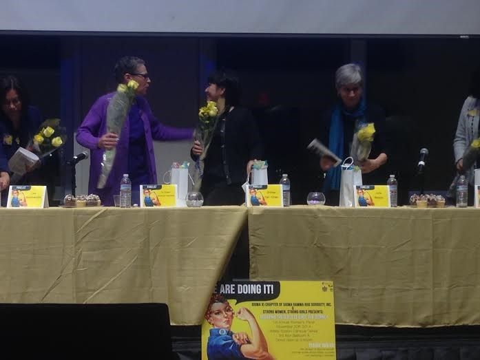 The+panelist+accepting+flowers+after+Q%26A