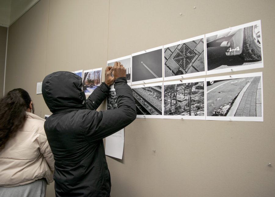 Photographers meet to discuss their own work and perform group critique at UMass Boston.