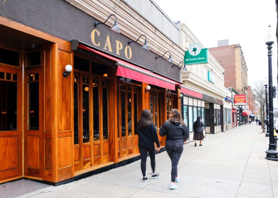 People walk past the Capo Restaurant & Supper Club in South Boston on Thursday, April 21, 2022.
