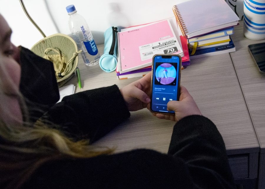 UMass Boston student Jackie Tucker sits in her dorm on Wednesday, March 30, 2022. She catches up on some old Harry Styles in preparation for the “Harry’s House” release.
