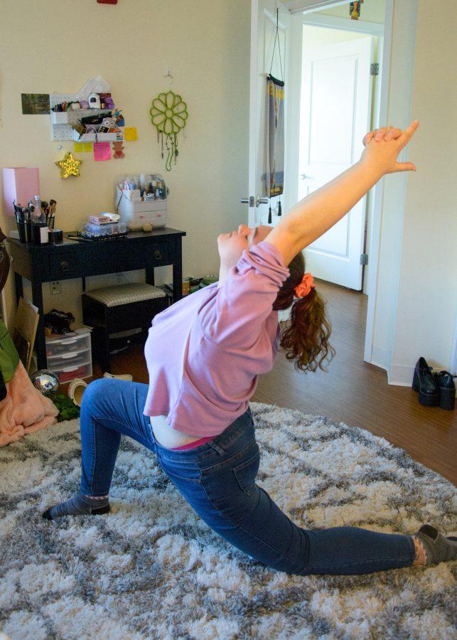 After a long first day of classes, a student de-stresses with some light yoga in her room.