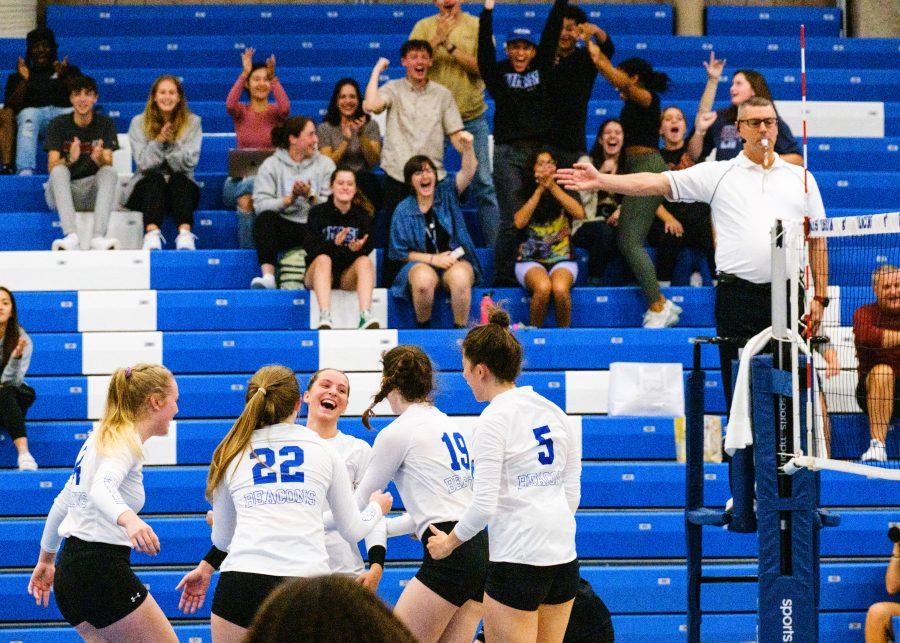 UMass Boston women’s volleyball players celebrate after winning a point in the match against Brandeis University at the Clark Athletic Center on Tuesday, Sep. 13, 2022.