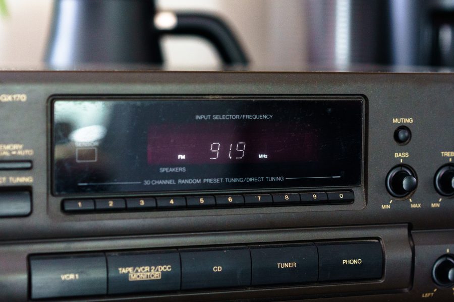 A Technics receiver sits atop the counter, tuned to 91.9 FM.