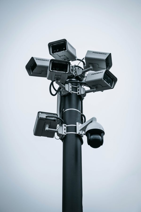 A pole riddled with security cameras and other surveillance equipment.