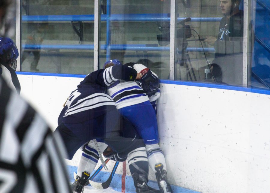 Men’s hockey players in a mighty tussle.