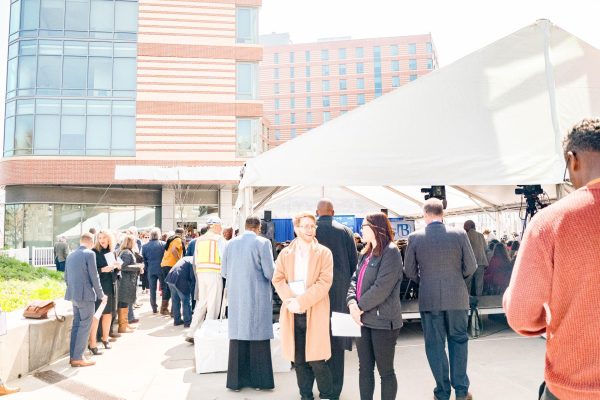 A crowd gathers outside the residence halls for the building dedication ceremony on April 28, 2023. Photo by Olivia Reid / Photography Editor. 