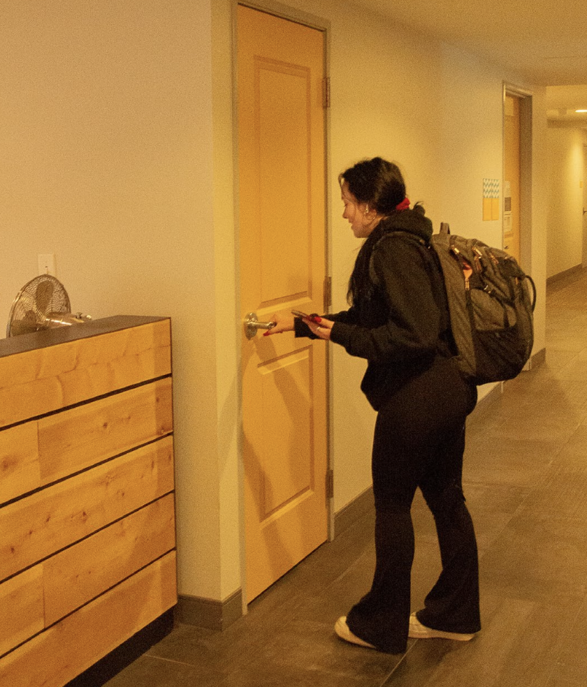 A student passes through the lobby of Peninsula Apartments. Photo by Olivia Reid (She/Her) / Photography Editor.
