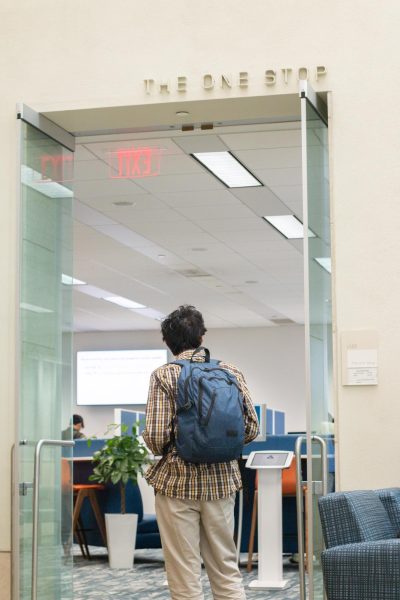 A student enters The One Stop to get financial aid advice. Photo by Colin Tsuboi / Mass Media Staff