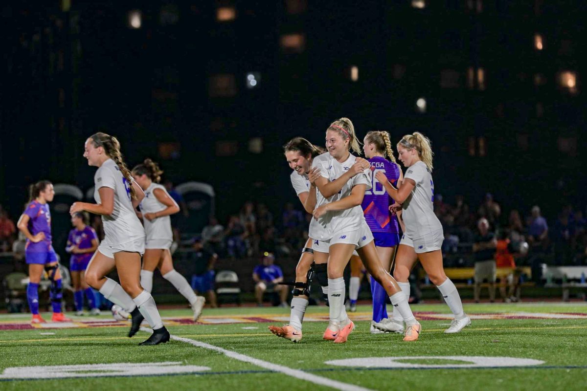 Women’s soccer celebrates after a goal. Photo by Beacon Athletics.