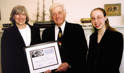 John Siegenthaler presents Emily Ullman (right) with a certificate honoring her first-place in the 2002 Profile in Courage Essay Contest. Patricia Hans (left), Emily?s nominating teacher, was recognized with a $500 John F. Kennedy Service Grant to encourage student leadership and civic engagement. The contest and awards are underwritten by Fidelity Investments.
 