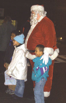 Santa poses with neighborhood children at a tree lighting in Peabody Square.
 
