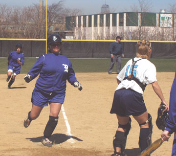 Stephanie Poulos scores and centerfielder Stacey Peterson follows suit to give the Beacons the lead 5-4 in their win over Lasell. - Photo by Ennio Bozzetti
 