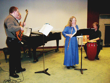 (From left to right) Andy Brewster (bass), Katherine Kleitz (flute), and Seth Hamlin (congas) warm up for Rabiosa during the UMass Boston faculty music performance on April 14. - Photo by Mimi Yeh
 