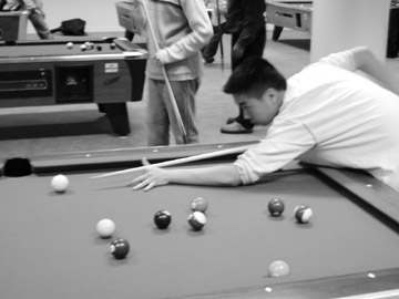 Students competed last Thursday and Friday in a pool and game tournament. Prizes included a sharp new pool cue, high-grade ping-pong paddles, a marble chess set, a Boston Bruins Jersey, and gift certificates. Employees said that the event was a chance to make the new game room sparkle. The game room includes pool, ping-pong, air hockey, chess, dominos, cards, and of course an arcade loaded with new games. After working up a appetite from all the fierce competition the good people at the game fed the masses with free pizza and popcorn! - Photos By Tony Naro
 