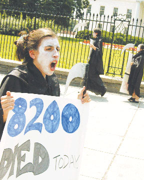 Student global AIDS Campiagn demonstartors, dressed as grim reapers, protest Bush administration policies on AIDS
 