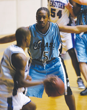Senior Roger Perry (center) has 1,114 career points and stands sixth in UMB history.
 