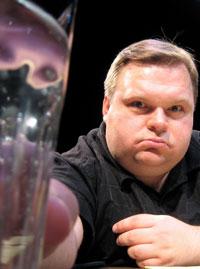 Mike Daisey and his glass of water in Invincible Summer
 