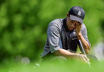 ROCHESTER, NY - AUGUST 14: Tiger Woods of the USA wipes his forehead on the seventh green during the first round of the 85th PGA Championship at Oak Hill Country Club on August 14, 2003 in Rochester, New York. (Photo by Jamie Squire/Getty Images)
 