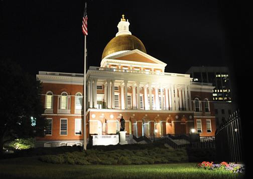 The Massachusetts State House, illuminated at night.
