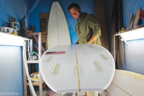 Emery with one of his custom surfboards.
