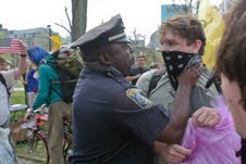 An officer strong-arming a protestor at a Boston rally; the photo that went viral and got everyone talking.
