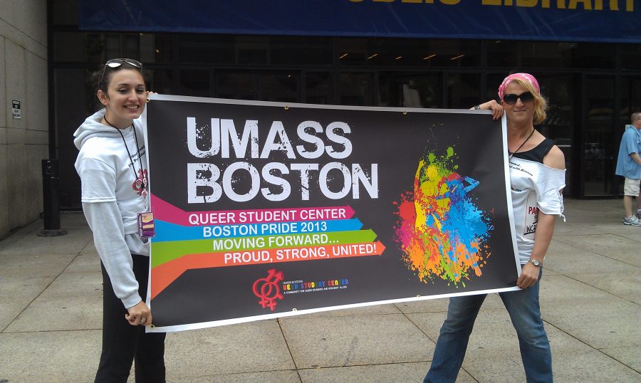 Cheyenne Fox Tree-McGrath (left) and Stephanie Bonvissuto (right) hold up the Q's marching banner
