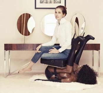 Captured above: Famous model, Dasha Zhukova, poses on a chair made to resemble a bound, black woman. 
