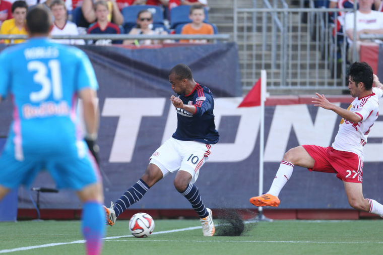 Teal Bunbury plays the ball, with Robles looking on