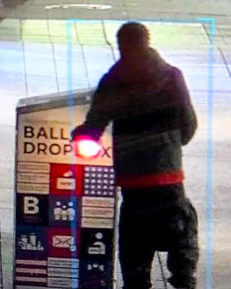 Surveillance footage of man setting fire to the drop box.
