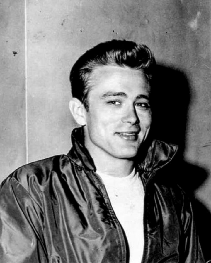 Photograph of James Dean posing for a fan.