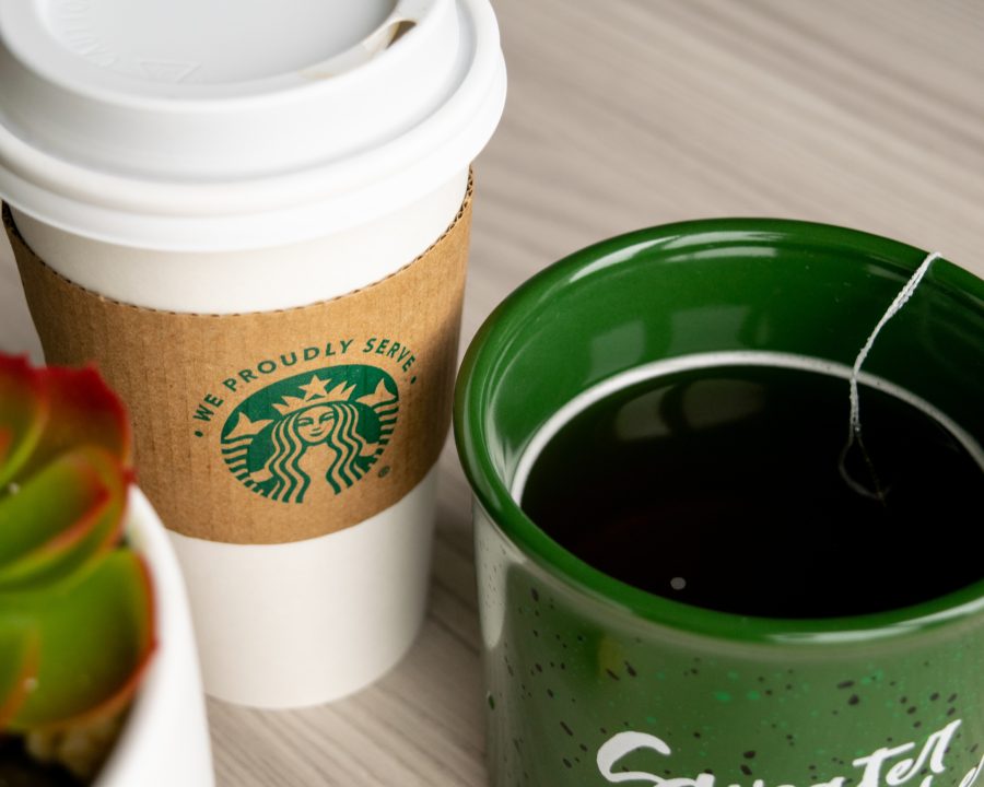 Starbucks+Coffee+and+a+cup+of+tea+sit+side+by+side.