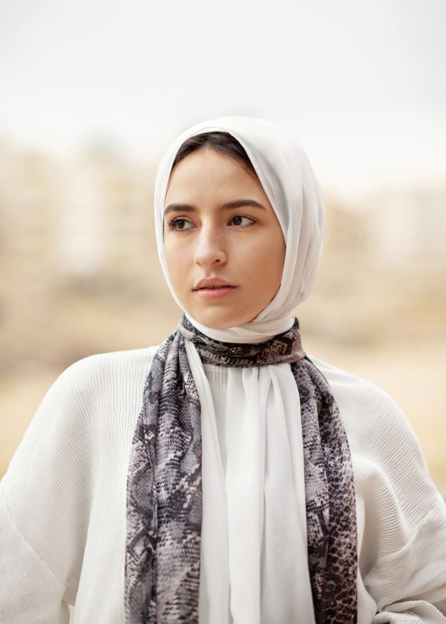 A woman poses while wearing a hijab.