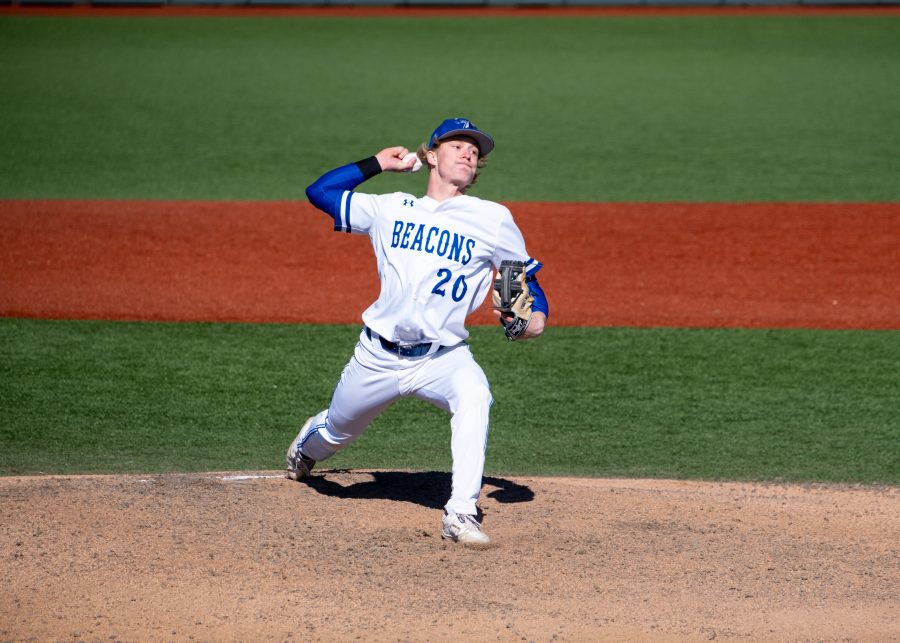 UMass Boston's Cole Porter (#20) pitches in the game against Johnson &amp; Wales University on March 22, 2022.