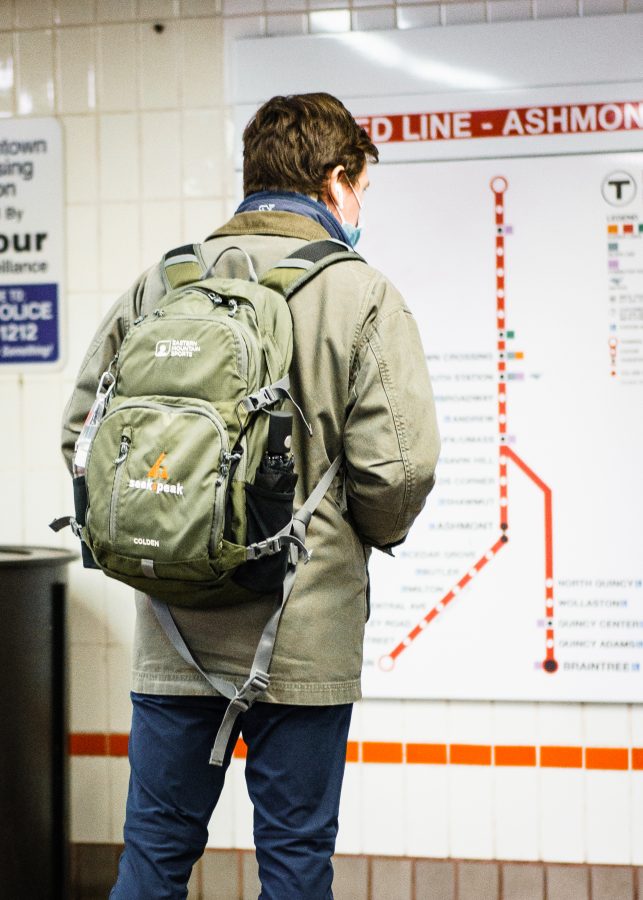 An MBTA passenger studies the Red Line map at Downtown Crossing.