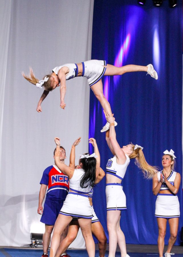 Olivia Moos (flyer), Emily Ireland (backspot), Maura Driscoll (base) and Meaghan Kertanis (base) perform at the Ocean Center in Daytona, Fla.