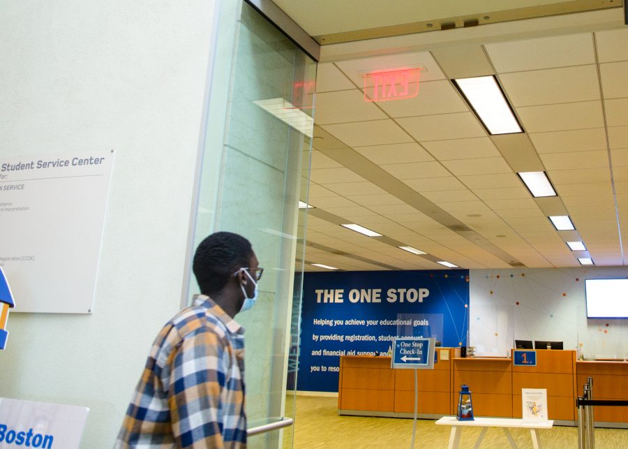 A UMass Boston student enters the One Stop within the Campus Center.