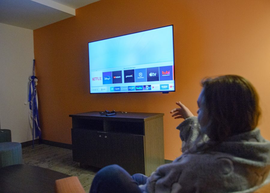 UMass Boston student Stacy sits down in the residence hall to catch up on the newest Netflix shows.