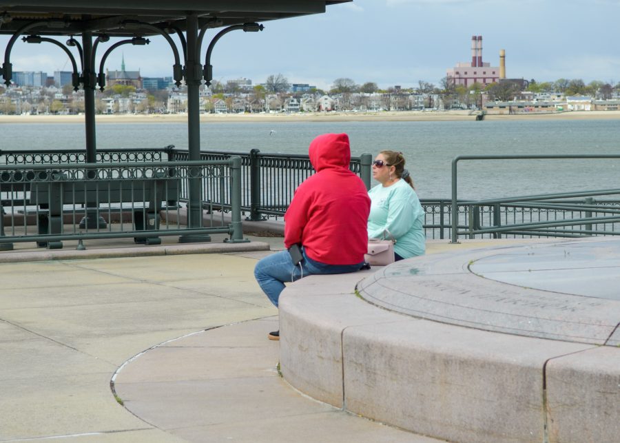 Two Harbor Point residents have a conversation on the Harbor Walk.