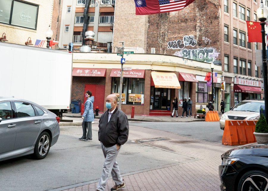 People walk through Chinatown in Boston, Mass.