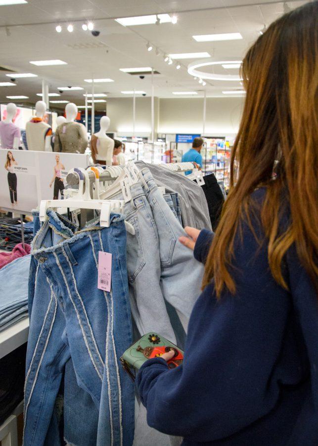 A student looks through the clothing racks at Target for some affordable back to school clothes.