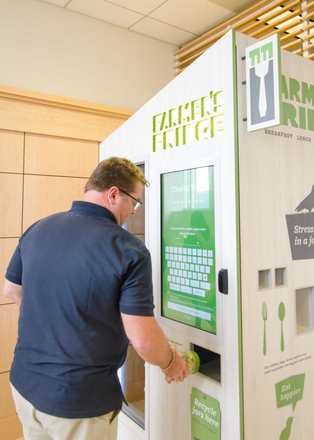 A UMass Boston student takes a moment to enjoy the new Farmer’s Fridge located in Campus Center near the bookstore. Use the code “HOCO25” to get a discount!