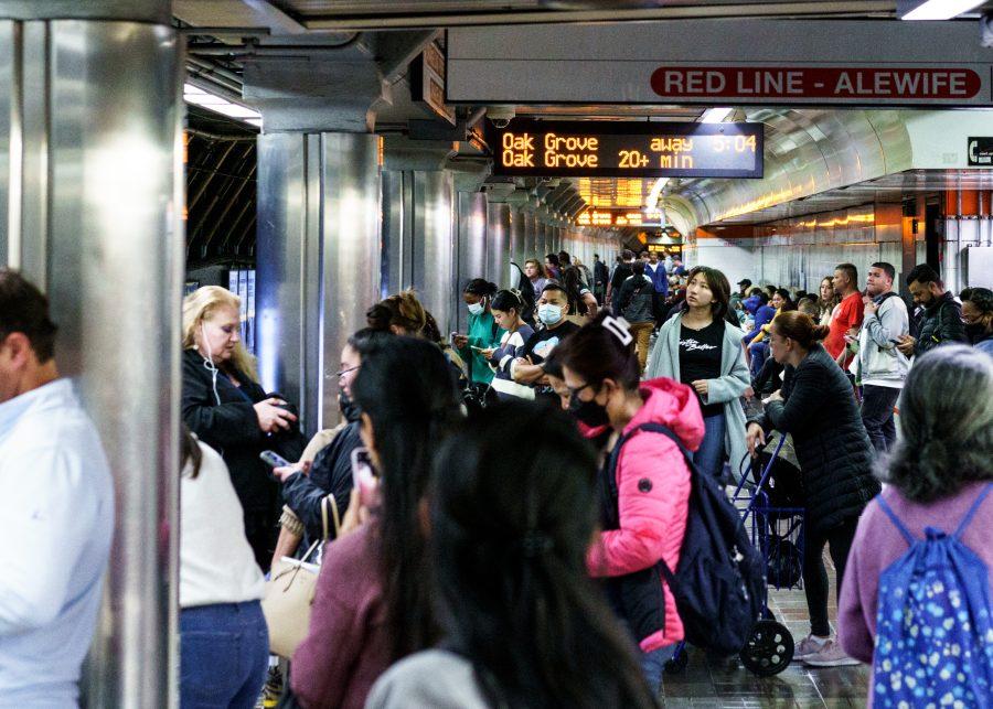 MBTA passengers crowd the platform awaiting their train.