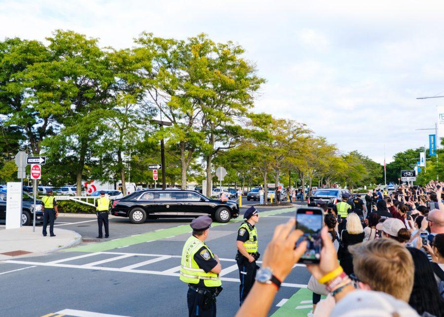 Dozens of people crowd in front of the JFK Library to see President Joe Biden’s motorcade as it leaves the UMass Boston campus on Monday Sep. 12, 2022.