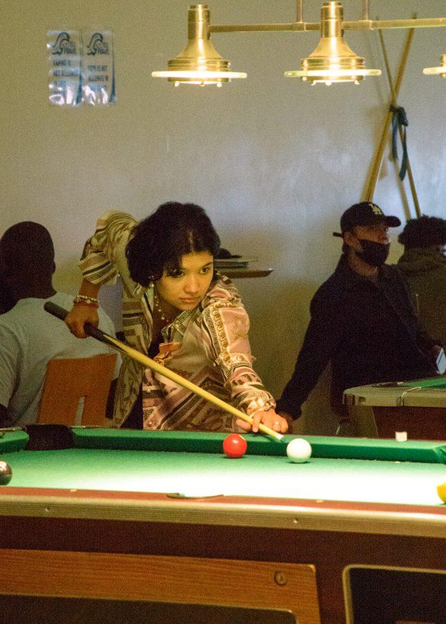 Students take advantage of the free pool table offered in the Campus Center’s game room.