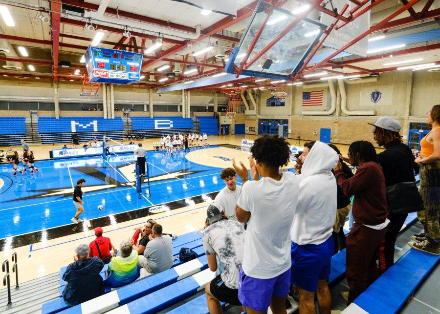 UMass Boston students cheer from the stands during a women’s volleyball match at the Clark Athletic Center.