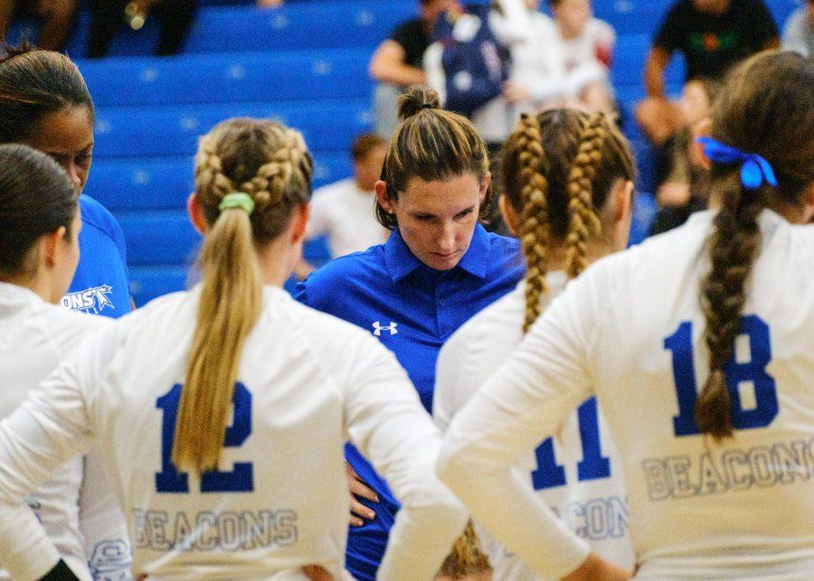 UMass Boston women’s volleyball team discuss strategy during a timeout in the match against Brandeis University at the Clark Athletic Center on Tuesday, Sep. 13, 2022.