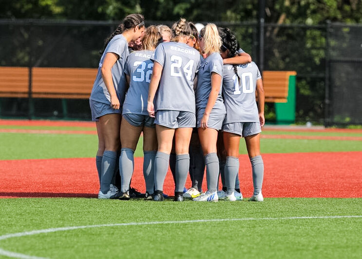 UMass Boston’s women’s soccer team huddles during their game against WestConn on Oct. 22, 2022.