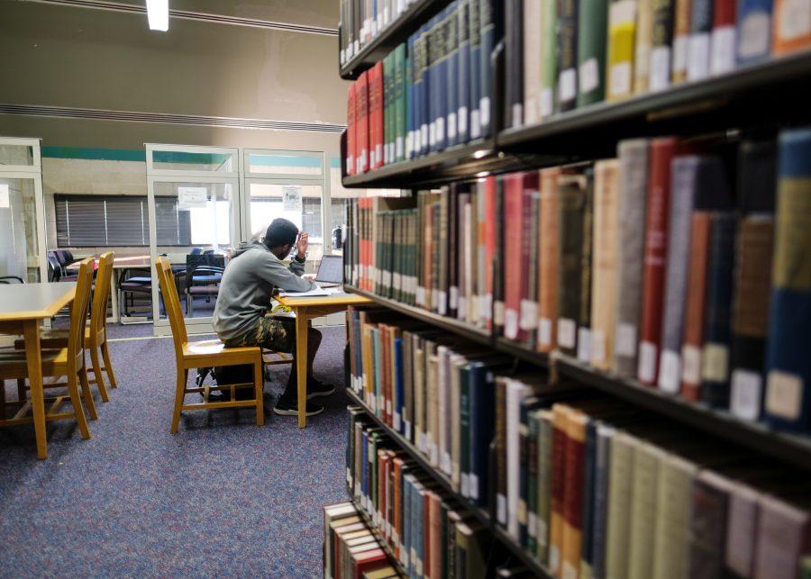 A student studies in the Healey Library after classes.
